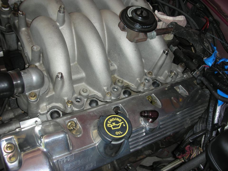 Engine intake manifold and valve cover with 'The Rocket Cough' text