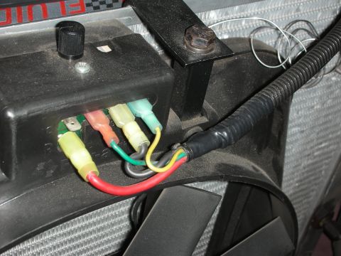 1992 Ford Crown Victoria - Wiring for an aftermarket fan controller is connected to a black box, with a fan and radiator visible in the background.