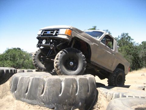 1989 Ford Bronco - This modified 1989 Ford Bronco navigates an obstacle course made of large tires.