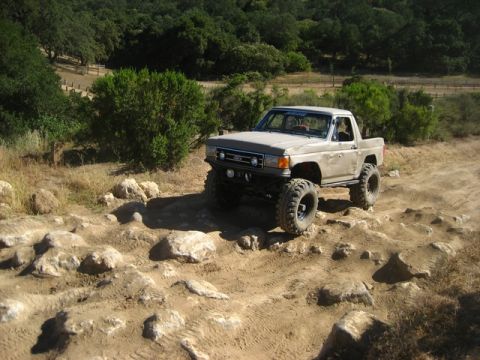 1989 Ford Bronco - This modified Ford pickup truck navigates a rocky off-road course.