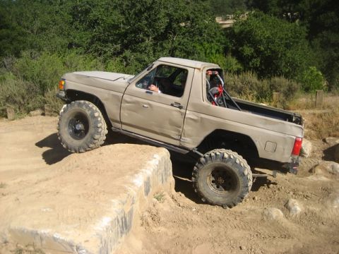 1989 Ford Bronco - This 1989 Ford Bronco navigates a challenging off-road course with large tires and a lifted suspension.