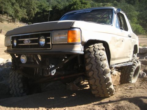 1989 Ford Bronco - This modified Ford Bronco is tackling a challenging off-road course.