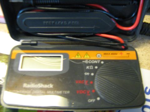 1988 Mercury Grand Marquis - A RadioShack digital multimeter is shown with its test leads connected.