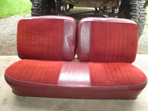 1989 Ford Bronco - Bench seat with red cloth and burgundy vinyl accents, likely from an older SUV or truck.
