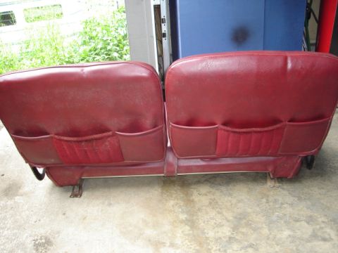 1989 Ford Bronco - Rear view of two red car seats with storage pockets.