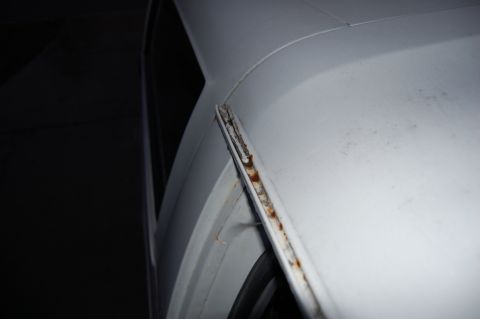 1994 Ford Bronco - Rust is visible along the seam of a white vehicle's body panel.