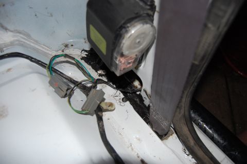 1994 Ford Bronco - Close-up of a seatbelt mechanism and wiring in a vehicle's interior, with a watermark visible.