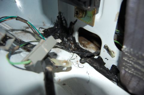 1994 Ford Bronco - Close-up view of a damaged wiring harness and melted insulation, suggesting potential electrical issues within the vehicle.