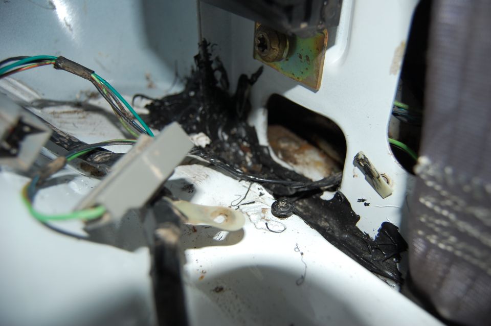 Damaged wiring harness and melted insulation inside a vehicle