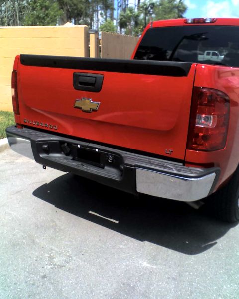 1993 Ford C-350 (Centurion Conversions) - Rear view of a red pickup truck showing the tailgate and bumper.