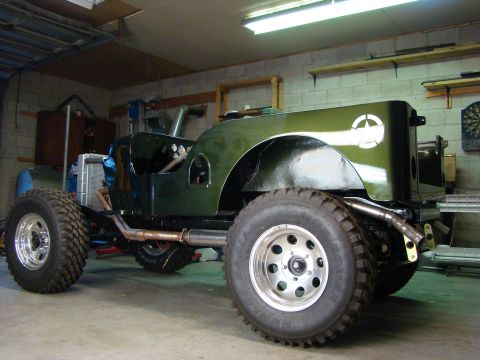 1948 Jeep Wrangler - This modified Jeep CJ-5 features a custom exhaust system and off-road tires, suggesting a build year between 1976 and 1983.