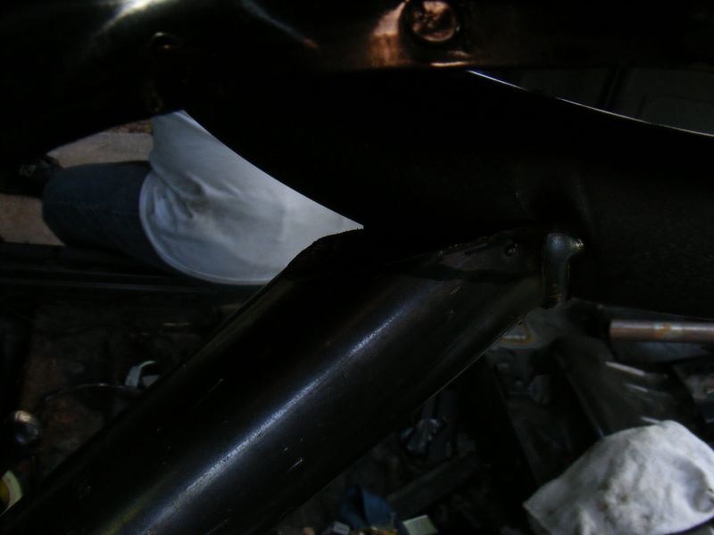 Close-up of a dark metal car interior component, possibly part of the dashboard or seat frame