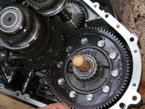 1989 Ford Escort - Internal view of a transmission showing complex gear mechanisms and a wooden dowel in a bearing.