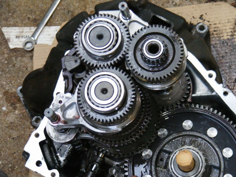 Close-up of internal gears and bearings within a mechanical assembly, with a wrench visible