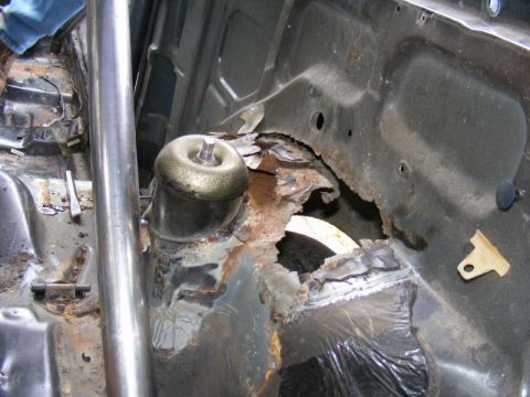 1989 Ford Escort - Significant rust has compromised the structural integrity of this vehicle's interior, particularly around the suspension mounting points.