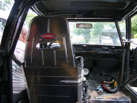 1989 Ford Escort - Custom interior with a racing seat and roll cage, view from passenger side.