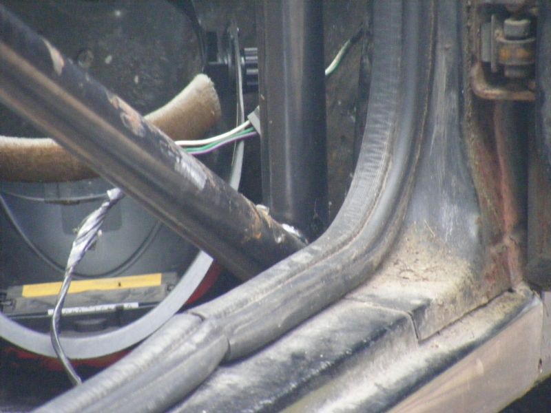 Close-up of interior door frame with exposed wiring and insulation