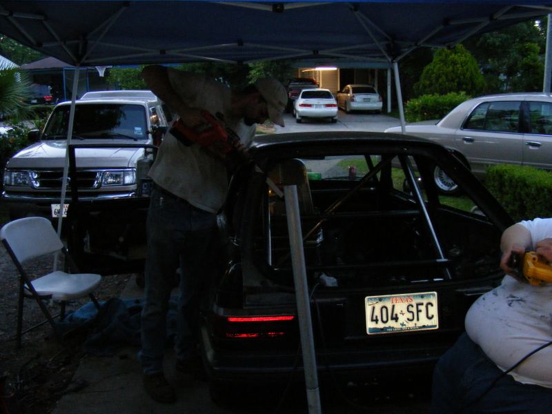 Black car's rear with roll cage, racing seat, and Texas license plate 404-SFC
