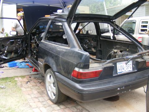 1989 Ford Escort - This 1989 Ford Escort is undergoing disassembly, with its doors and trunk wide open.