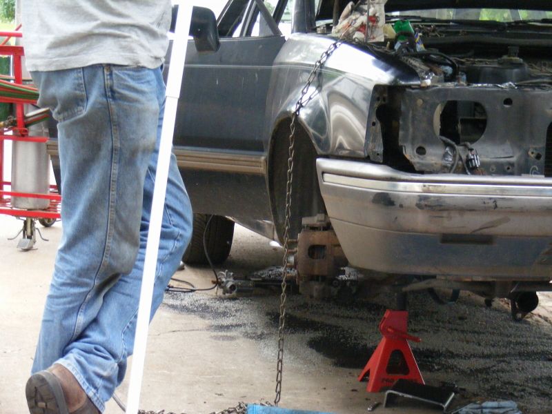 1989 Ford Escort front end on jack stands with engine exposed, undergoing repairs
