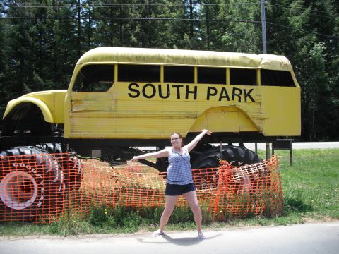 1991 Ford Bronco - A person poses in front of a yellow bus body mounted on a monster truck chassis, with 'SOUTH PARK' visible on the side.