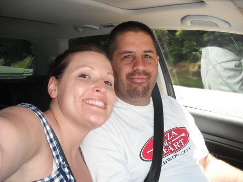 1991 Ford Bronco - A couple smiles for a selfie inside a car during a road trip.