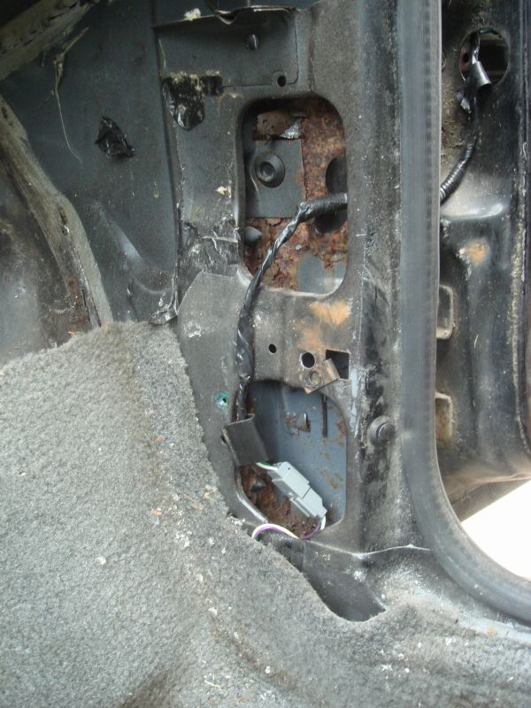 Interior door jamb with rust and wiring visible