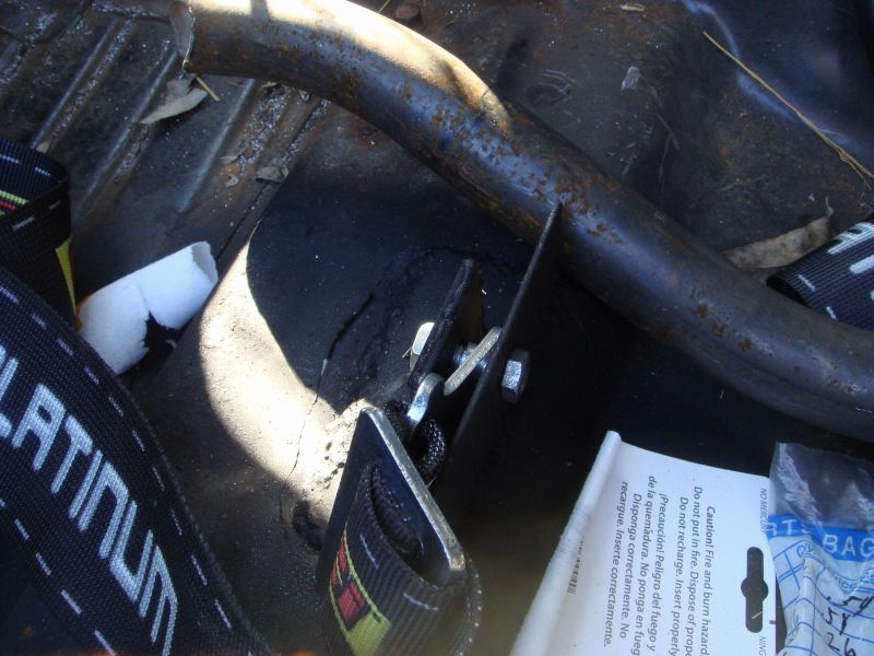 Close-up of a safety harness and roll bar inside a vehicle