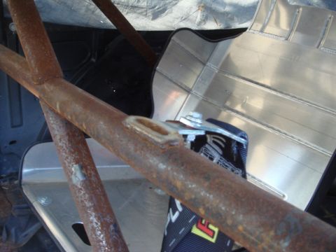 1989 Ford Escort - Close-up of a racing seat and roll cage, suggesting aftermarket modifications.