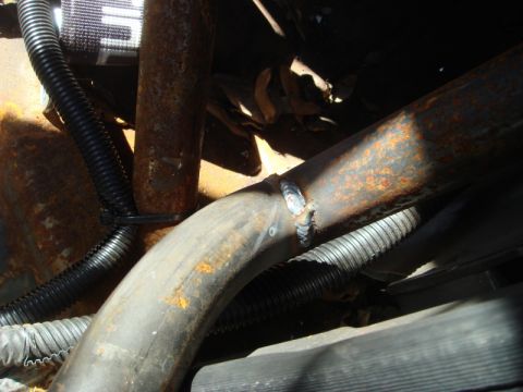 1989 Ford Escort - Detail of welded metal pipes and wiring, showing signs of rust and wear.