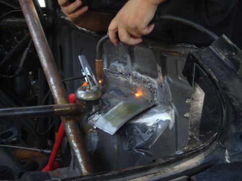 1989 Ford Escort - Welding work on a car's body structure, indicating repair or modification.