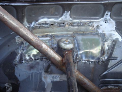 1989 Ford Escort - Welding and roll cage installation in a car's interior.