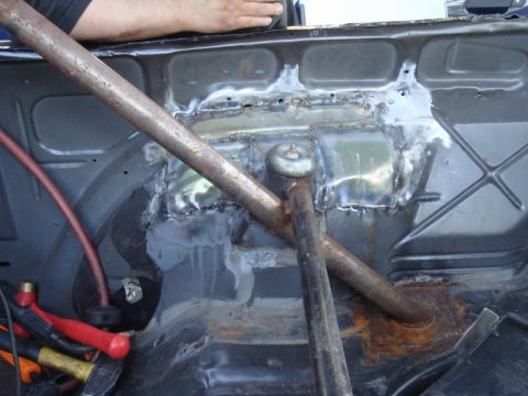 1989 Ford Escort - Interior view of a car undergoing welding repairs, with a roll cage and tools visible.