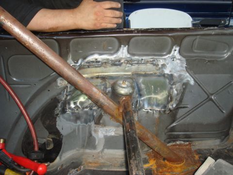 1989 Ford Escort - This image shows the interior of a car, focusing on the rear section where welding repairs have been made and a roll cage is installed.