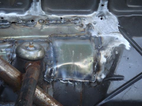 1989 Ford Escort - This image shows a section of a vehicle's chassis that has undergone repair with welding.
