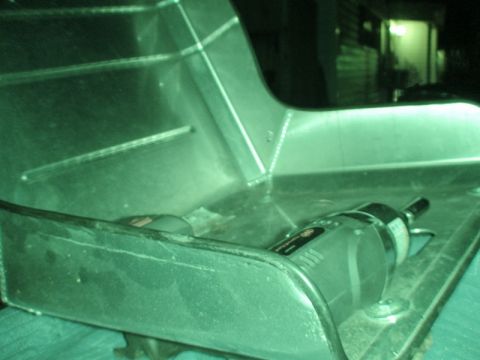1989 Ford Escort - A metallic car part is shown with a rotary tool on its surface.