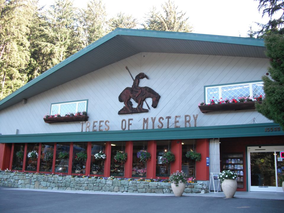 Trees of Mystery gift shop with large cowboy and horse sculpture above "TREES OF MYSTERY" sign