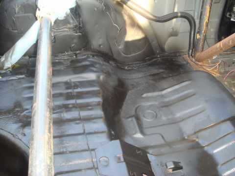 1989 Ford Escort - Interior view of a car's floor pan, showing exposed metal and roll cage components.