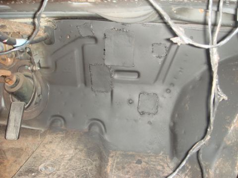 1989 Ford Escort - Firewall interior with welded patches and visible wiring, likely undergoing repair or restoration.