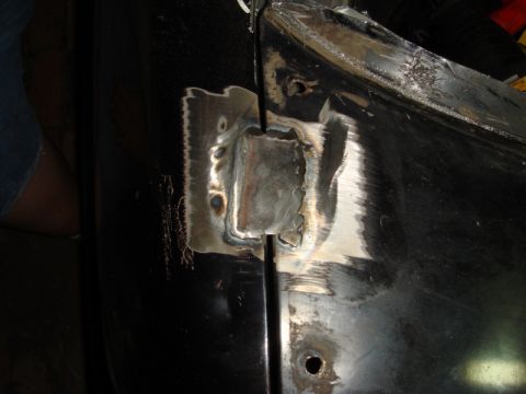 1989 Ford Escort - Welding repair work on a vehicle's door hinge mounting point.