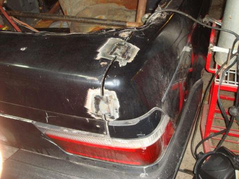 1989 Ford Escort - Bodywork in progress on the rear of a vehicle, with visible welds and filler material.