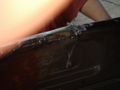 1989 Ford Escort - Close-up of welding work on the edge of a car door.