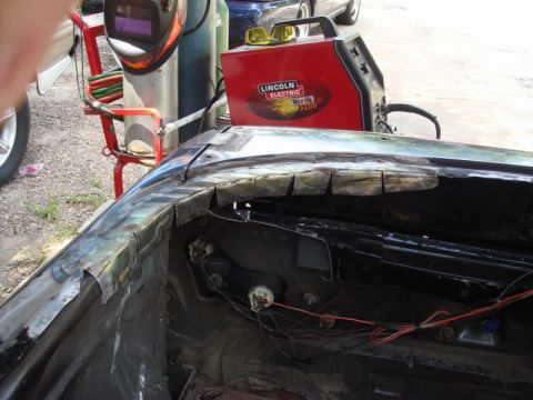1989 Ford Escort - Car body repair in progress with welding equipment and exposed internal wiring.