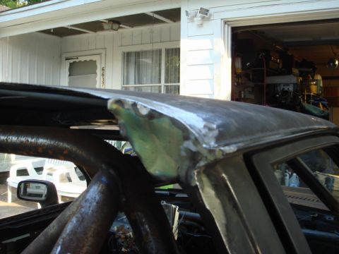 1989 Ford Escort - Custom roll cage installed in a car undergoing body modifications.