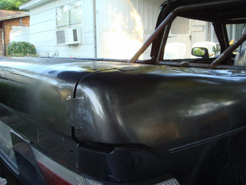 pickup truck bed with roll cage, shows damage on the top edge