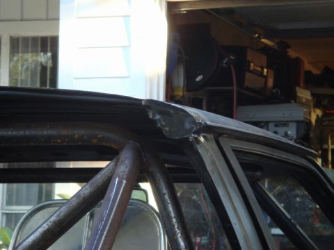 1989 Ford Escort - Roll cage structure visible inside a car's roofline, suggesting custom modifications.