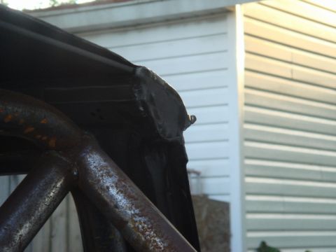 1989 Ford Escort - Detail of a roll cage and car roof edge, likely during a custom build or restoration project.