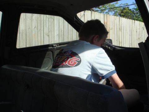 1989 Ford Escort - Interior view of a vehicle with a child seated in the back.