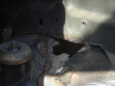 1989 Ford Escort - Significant rust has compromised the structural integrity of this wheel well.