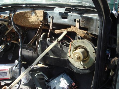 1989 Ford Escort - Interior view of a car dashboard with components removed, revealing the heater and blower assembly.
